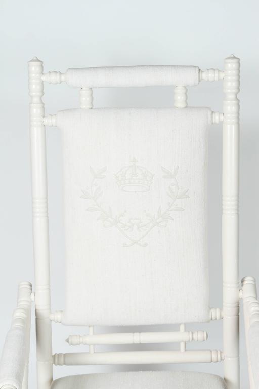 Antique Spring Rocking Chair. Newly painted. Newly upholstered in vintage linen. Custom embroidered crown and crest on seat back.